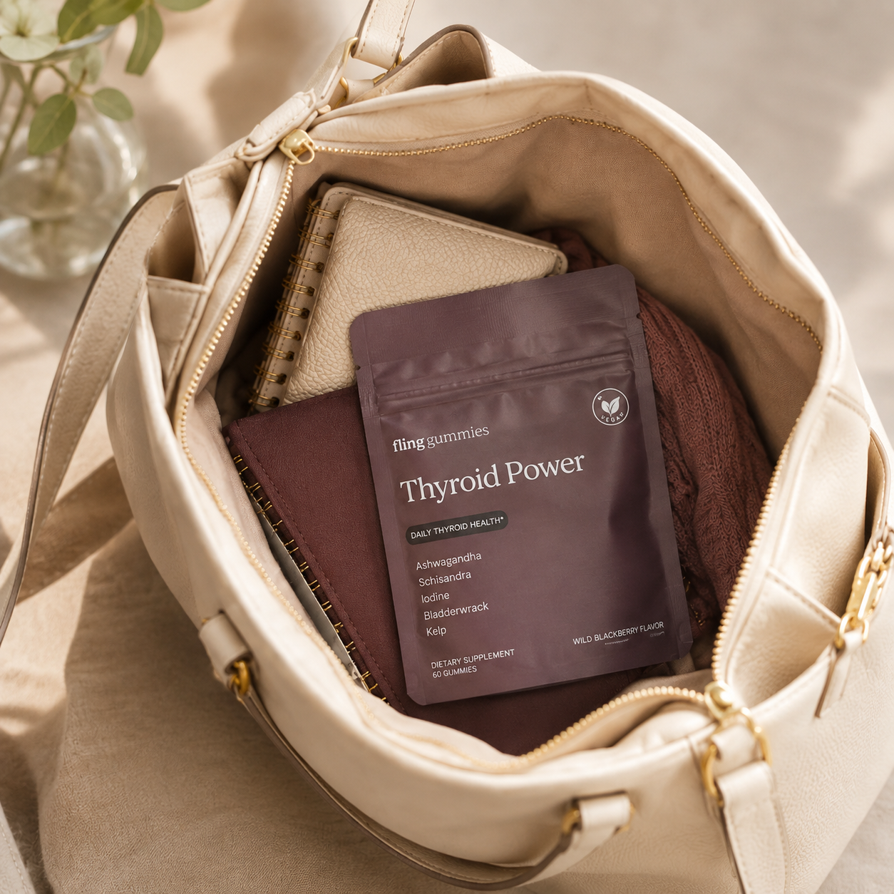 Thyroid Power pouch tucked into a handbag